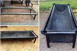 Livestock Feeding troughs with dip rollers for tick control